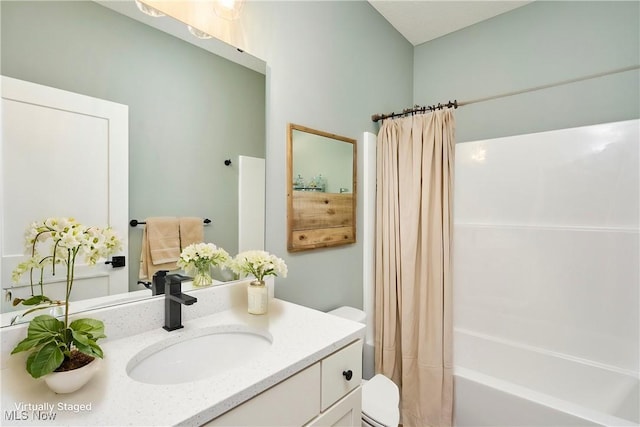 bathroom featuring vanity, toilet, and shower / bathtub combination with curtain