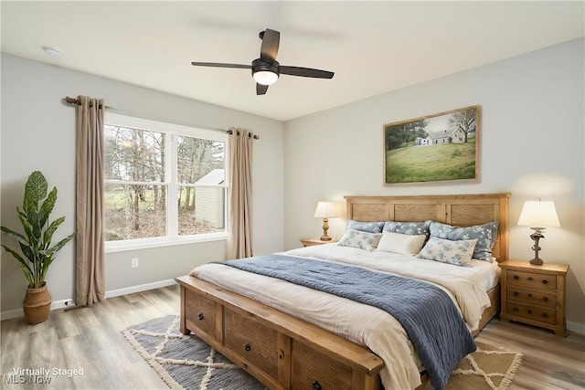 bedroom with baseboards, ceiling fan, and light wood-style floors