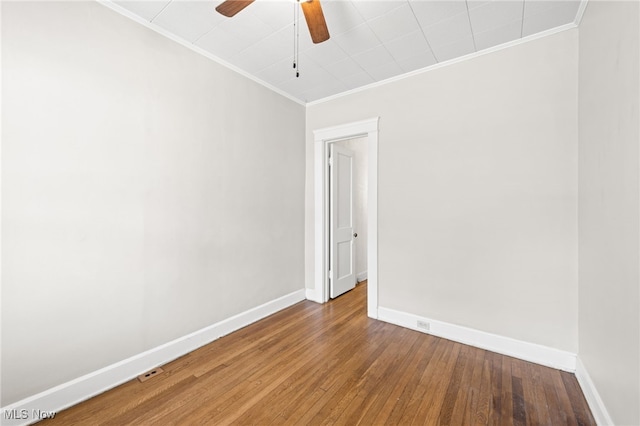 spare room with baseboards, ceiling fan, hardwood / wood-style floors, and crown molding