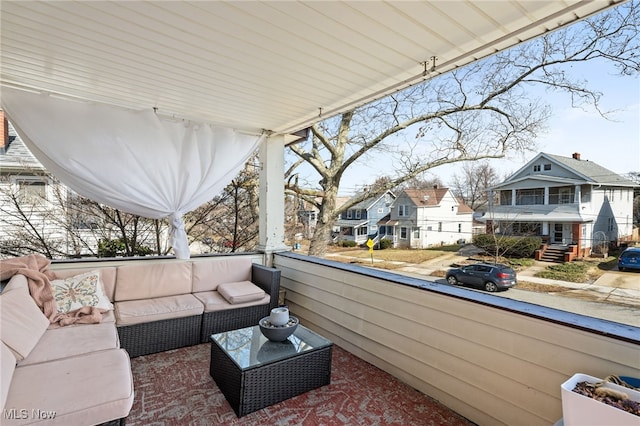 view of patio / terrace with a balcony, a residential view, and an outdoor living space