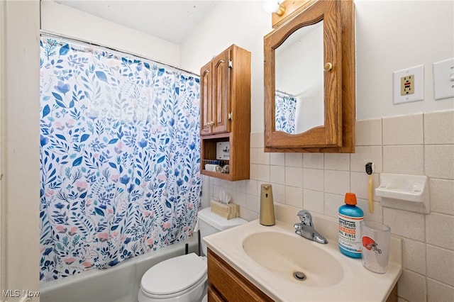 full bath featuring toilet, shower / bath combo, tile walls, and vanity