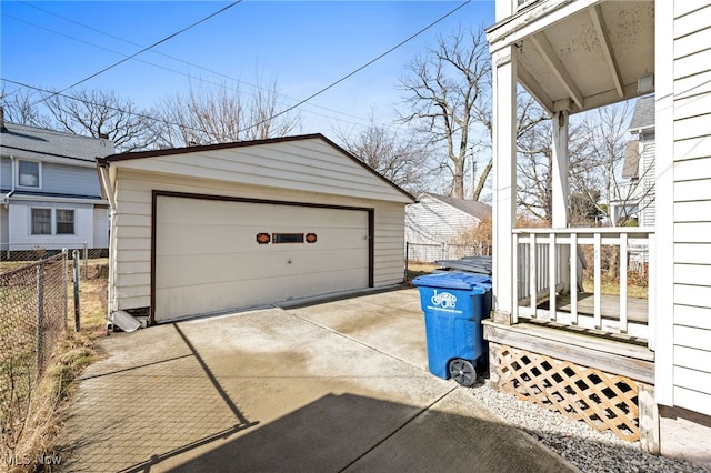 detached garage featuring fence