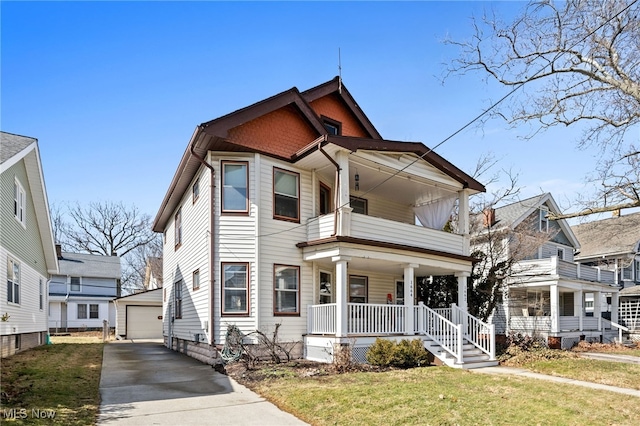 victorian house with a porch, a balcony, a garage, an outdoor structure, and a front yard