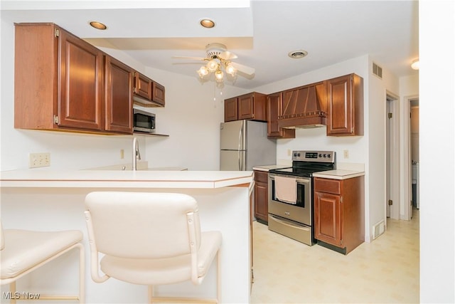 kitchen featuring custom exhaust hood, visible vents, a peninsula, and appliances with stainless steel finishes