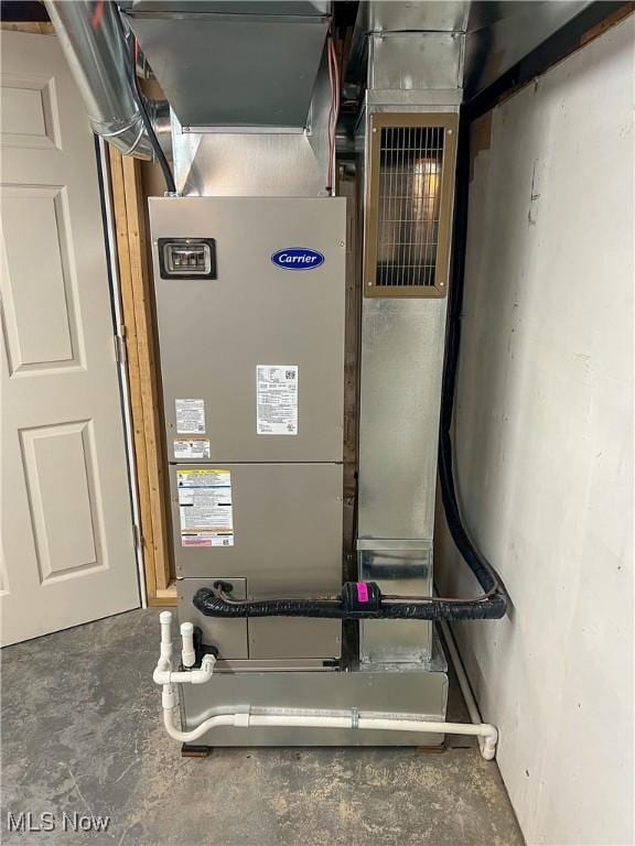 utility room featuring heating unit