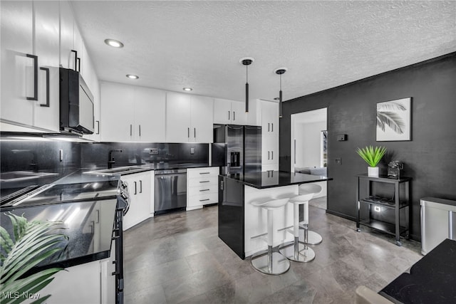 kitchen with dark countertops, dishwasher, and black fridge