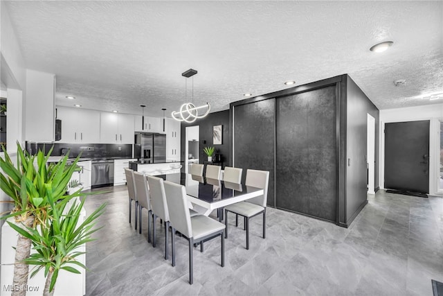 dining space with recessed lighting and a textured ceiling