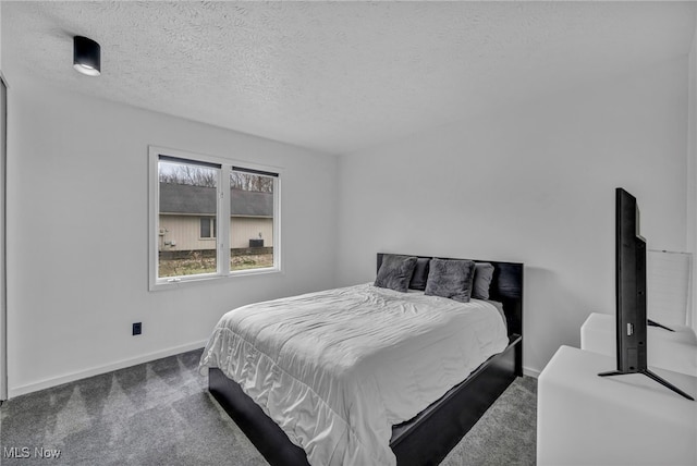 carpeted bedroom with a textured ceiling and baseboards