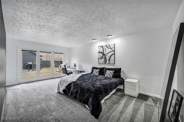 bedroom featuring access to outside, carpet flooring, a textured ceiling, and baseboards