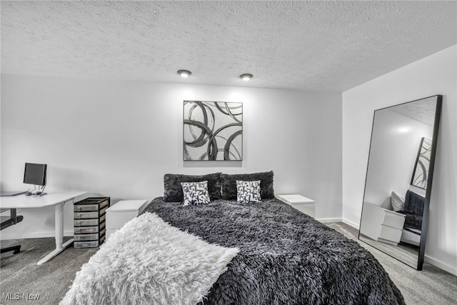 carpeted bedroom featuring a textured ceiling and baseboards