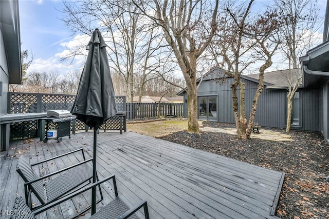 wooden terrace with fence and area for grilling