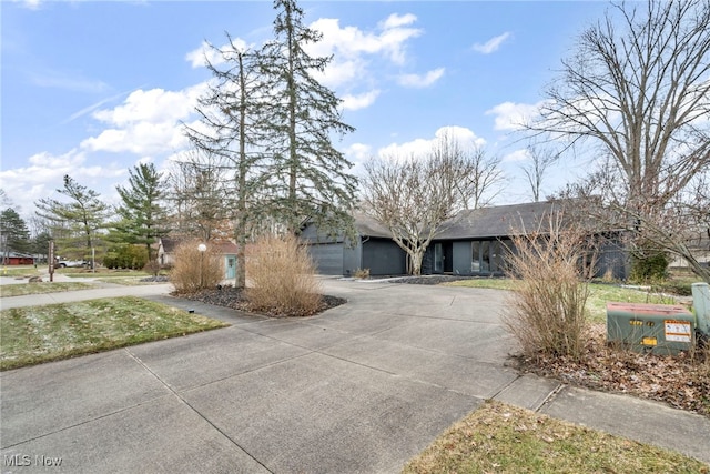 view of front facade featuring concrete driveway and an attached garage