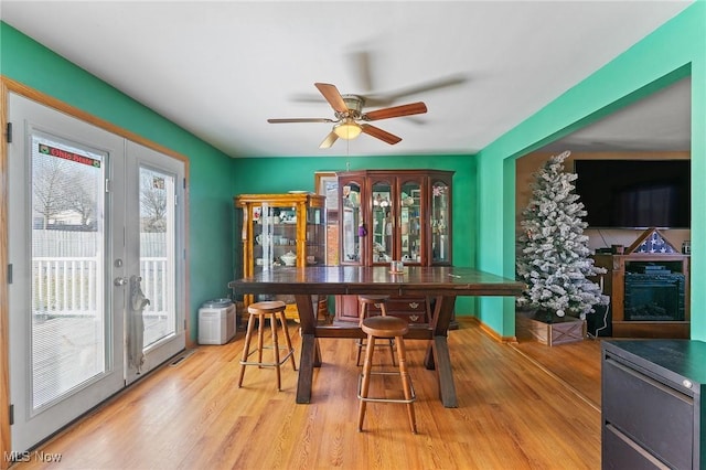 dining room with light wood-type flooring and a ceiling fan