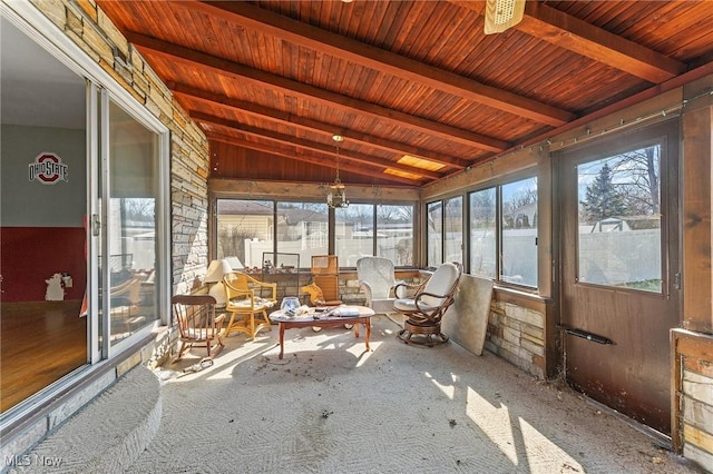 unfurnished sunroom featuring lofted ceiling with beams, plenty of natural light, and wood ceiling