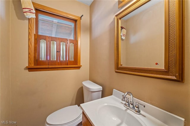 bathroom featuring toilet and vanity