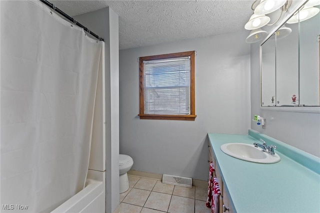 bathroom featuring visible vents, toilet, vanity, a textured ceiling, and tile patterned floors