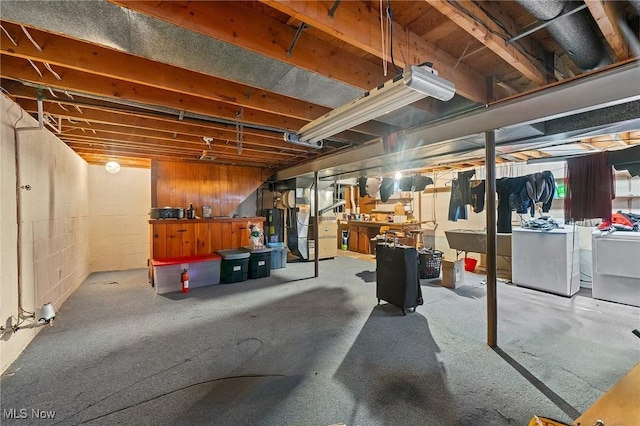 basement featuring washing machine and dryer and heating unit