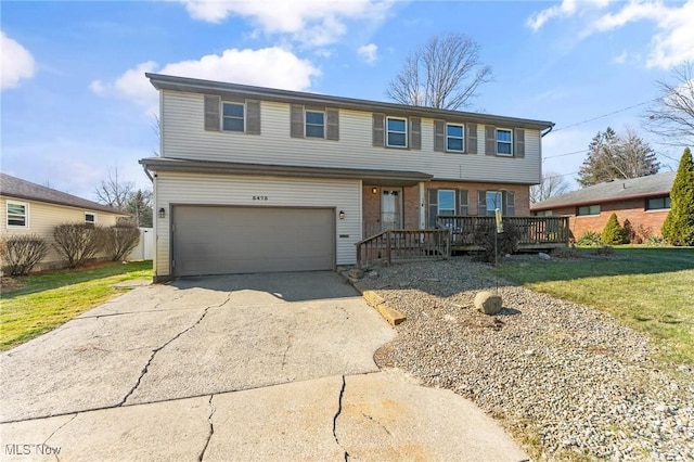 view of front of property with a garage, concrete driveway, and a front lawn