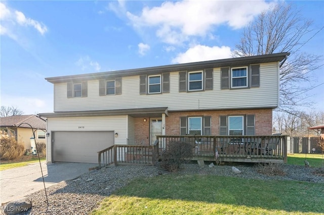 view of front facade featuring a garage, concrete driveway, brick siding, and a front yard