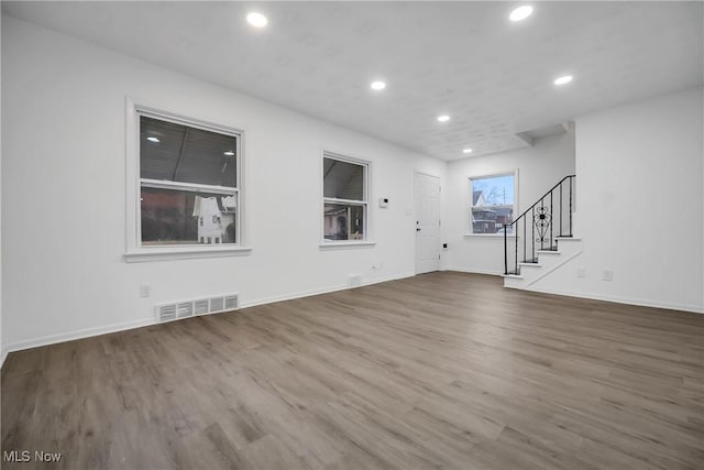 interior space featuring stairs, visible vents, wood finished floors, and recessed lighting