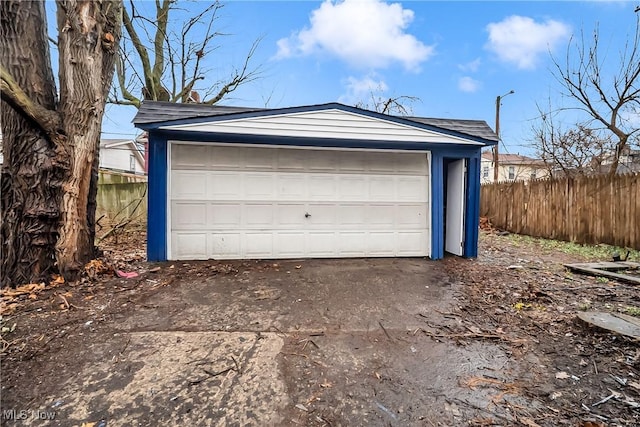 detached garage featuring fence