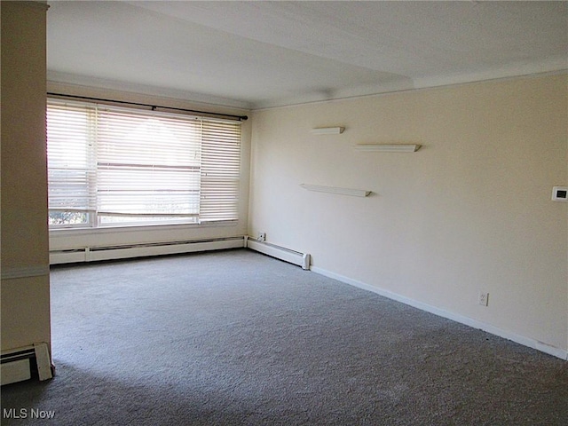 spare room featuring carpet floors, baseboards, and baseboard heating