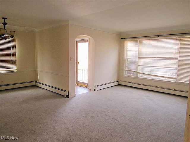 unfurnished room featuring arched walkways, carpet floors, and a notable chandelier