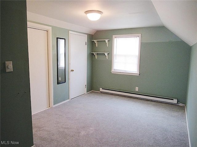 interior space featuring vaulted ceiling and baseboard heating