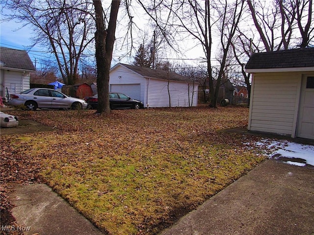 view of yard with an outbuilding and a detached garage