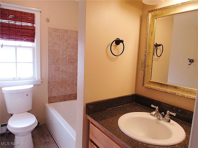 full bathroom featuring toilet, wood finished floors, and vanity