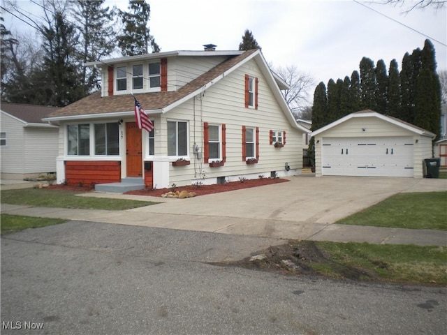 view of front of house featuring a garage, roof with shingles, and an outbuilding