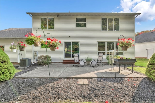 back of house featuring entry steps, a patio, and central AC unit