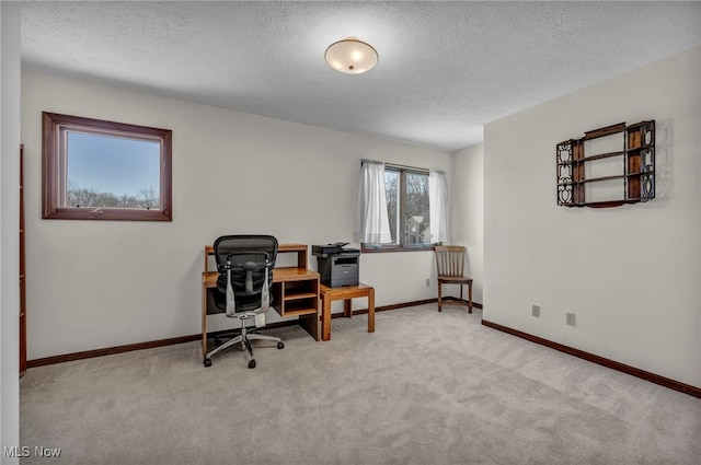 home office with a textured ceiling, carpet floors, and baseboards