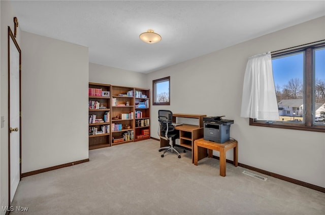 office area featuring carpet, visible vents, and baseboards