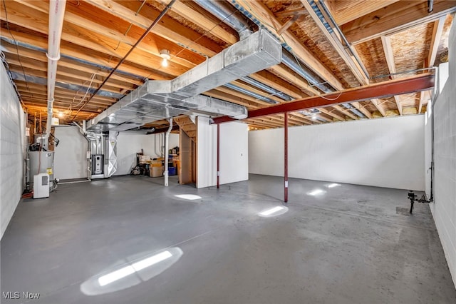 unfinished basement with water heater and heating unit