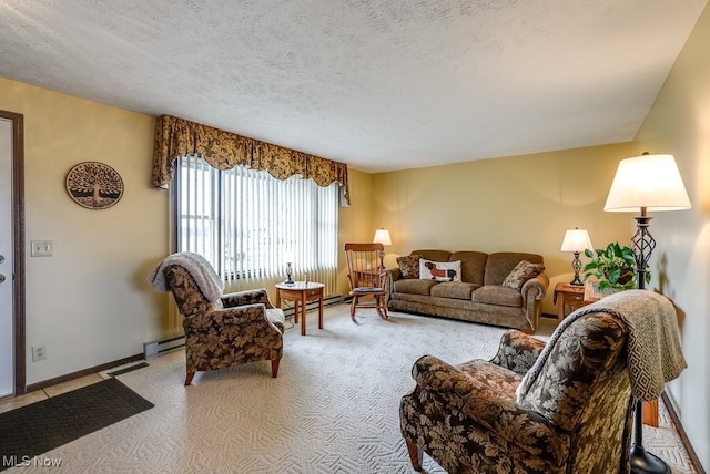 living area featuring light carpet, baseboards, a baseboard heating unit, and a textured ceiling