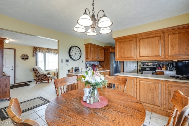 dining space with light tile patterned floors, a textured ceiling, light colored carpet, a notable chandelier, and baseboard heating