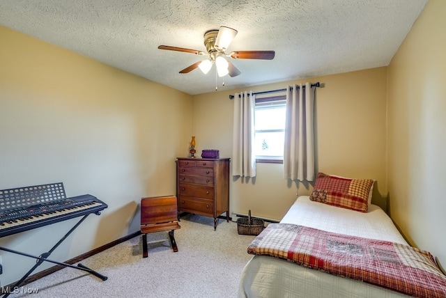 bedroom with carpet floors, baseboard heating, a textured ceiling, and baseboards