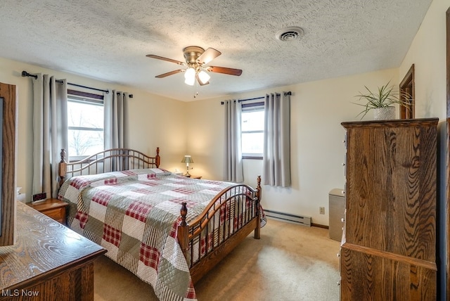 bedroom featuring visible vents, light carpet, baseboard heating, and multiple windows