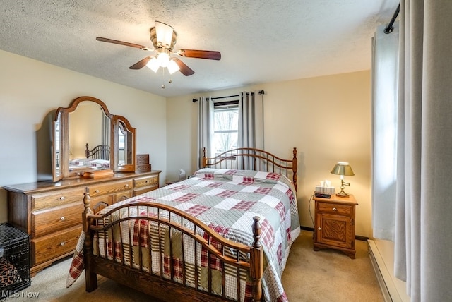 bedroom featuring a baseboard heating unit, light carpet, ceiling fan, and a textured ceiling