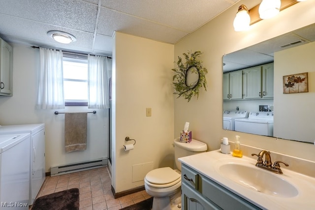 full bath with baseboard heating, visible vents, washer and clothes dryer, and tile patterned floors