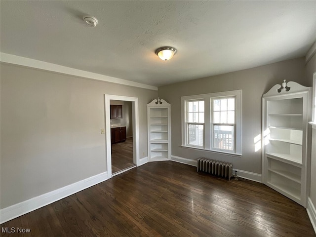 3096 Meadowbrook Blvd, Cleveland Heights, OH 44118 - empty room with a textured ceiling, dark wood-type flooring, radiator heating unit, and baseboards