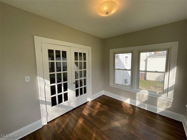 3096 Meadowbrook Blvd, Cleveland Heights, OH 44118 - empty room with dark wood-style floors, french doors, and baseboards