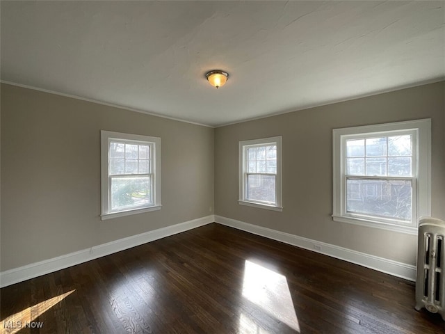 3096 Meadowbrook Blvd, Cleveland Heights, OH 44118 - empty room featuring baseboards, dark wood finished floors, and radiator
