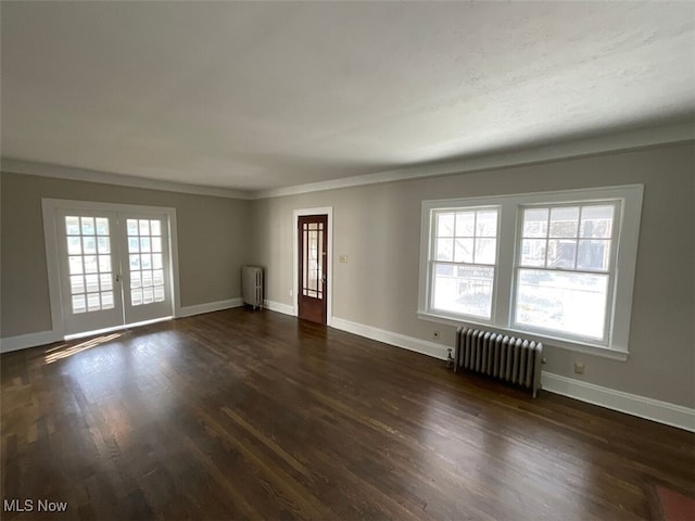 3096 Meadowbrook Blvd, Cleveland Heights, OH 44118 - unfurnished living room featuring plenty of natural light, radiator heating unit, and dark wood-style floors