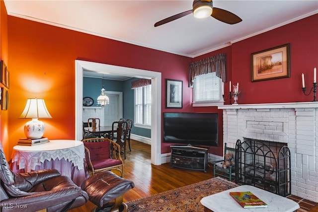 1518 Washington Ave, Parkersburg, WV 26101 - living area featuring a fireplace, crown molding, a ceiling fan, wood finished floors, and baseboards
