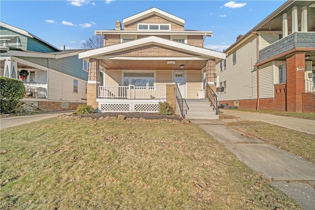 view of front facade with covered porch and a front lawn