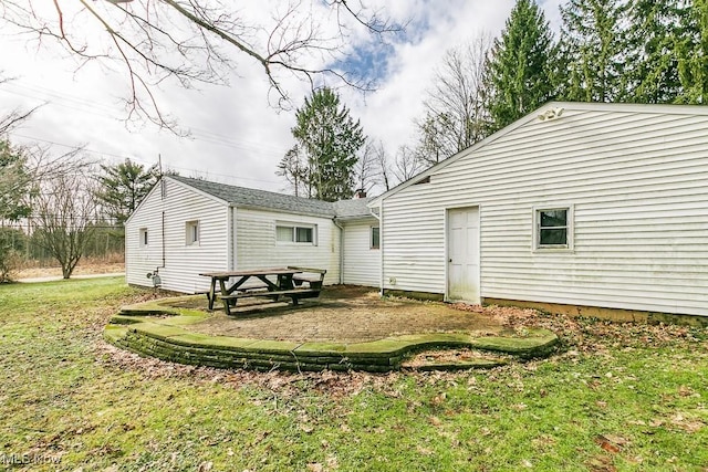 rear view of house featuring a yard