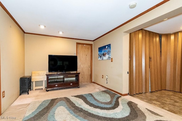 living area featuring a wood stove, crown molding, and baseboards