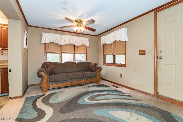 living area with baseboards, visible vents, ornamental molding, and a ceiling fan